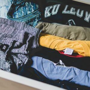 A neat arrangement of clothes and T-shirts in a drawer, showcasing casual wear.